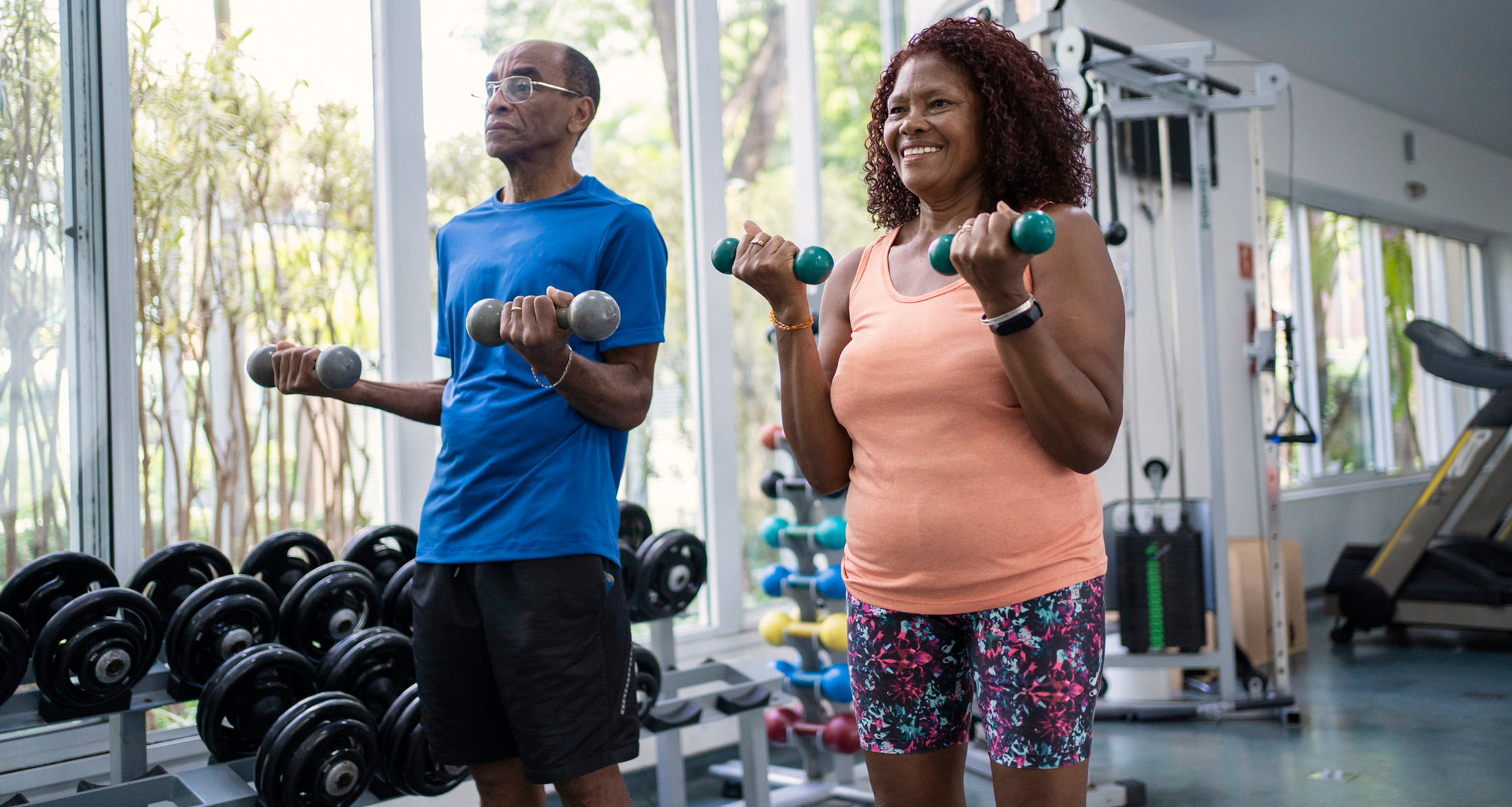 Retired couple working out with weights.