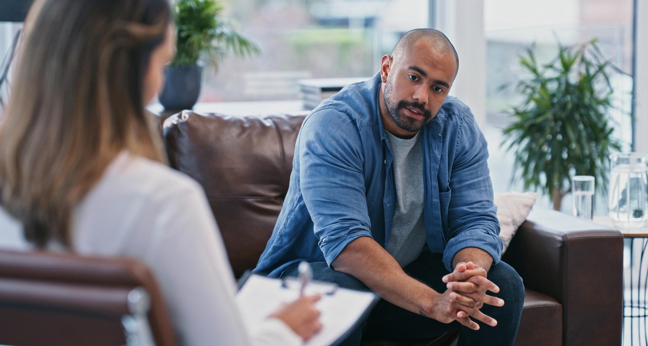 A male Veteran is discussing anger management with a psychiatrist.