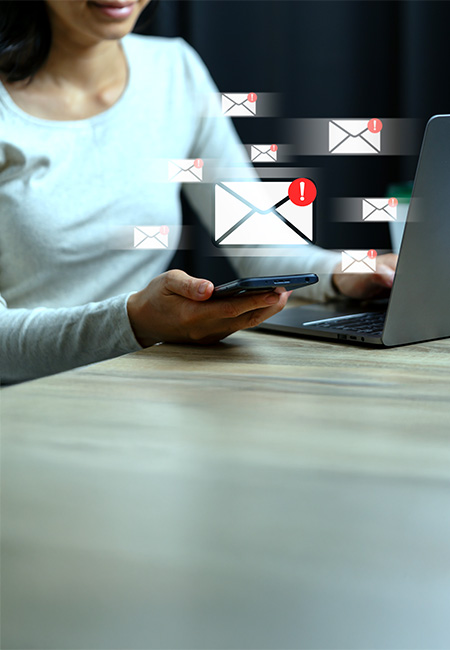 A woman receiving email threats depicting cyberbullying.