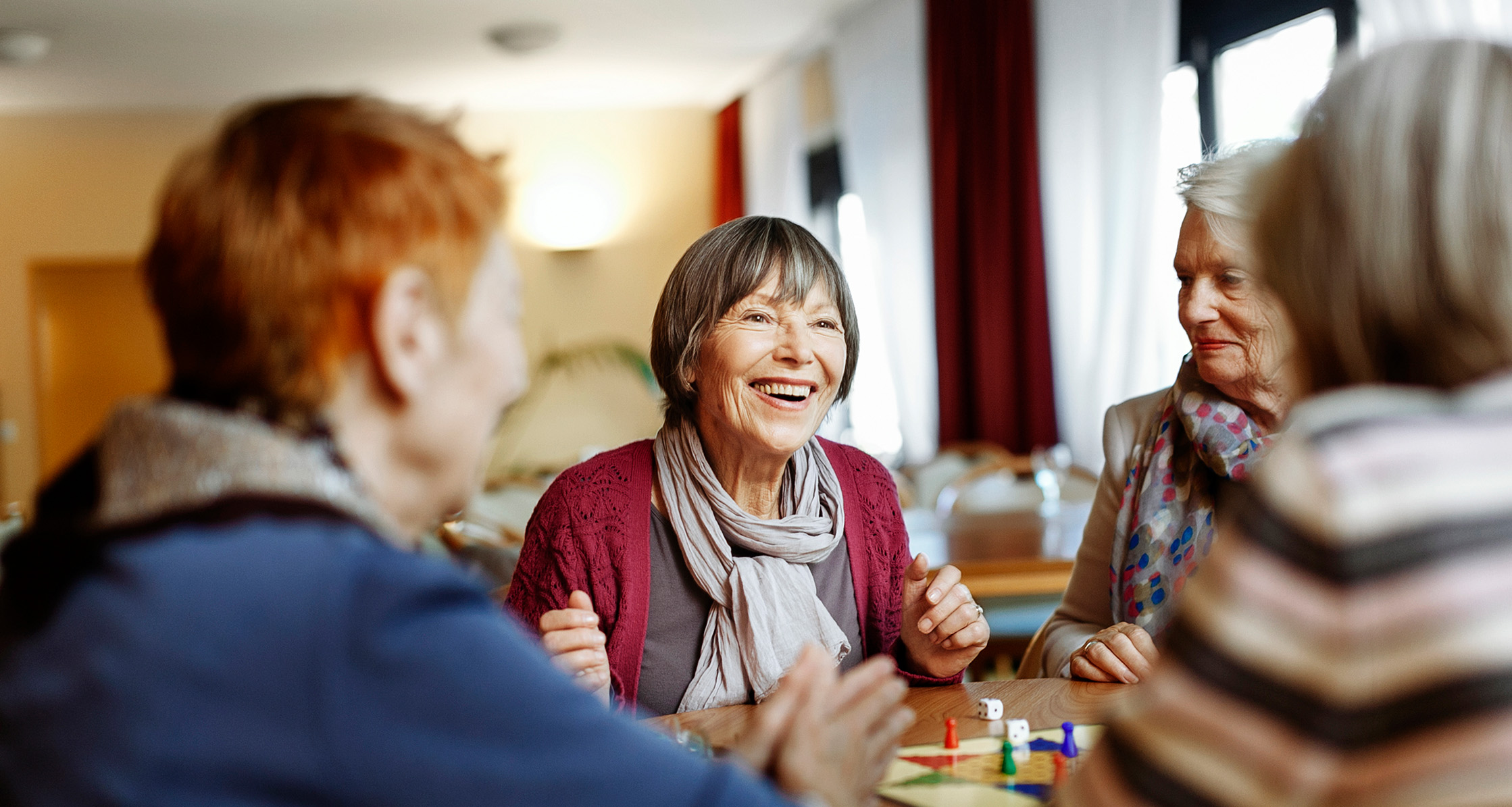 Retired women playing a board game.