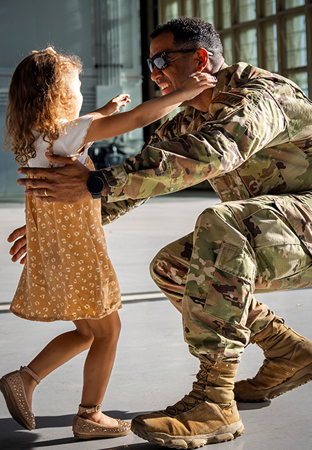 A Service member is warmly welcomed home by his young daughter.