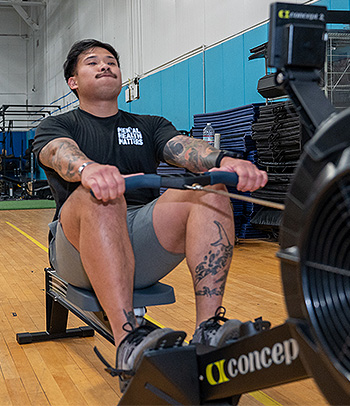 A Service member using a Concept2 Rower for exercise recovery.