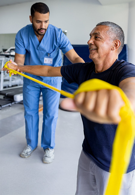 A retired Veteran undergoing physical therapy with a therapist.