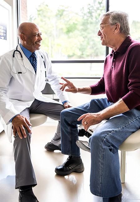 A retiree discusses his health plan with his doctor.