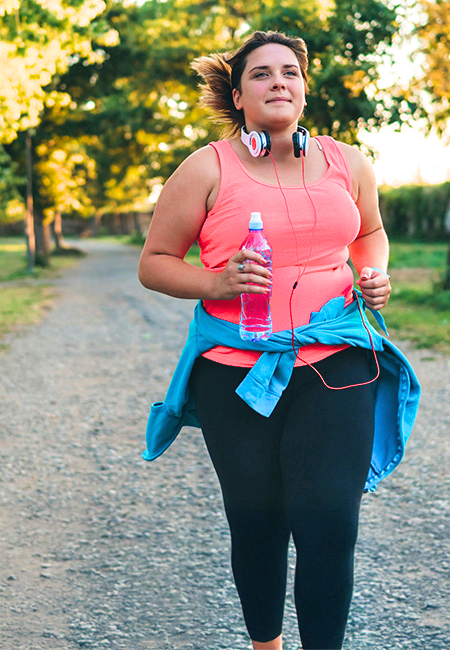 A woman is jogging in the spring.