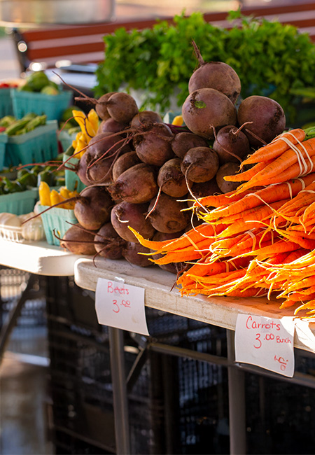 Bundles of carrots and beets at a local farmers market.