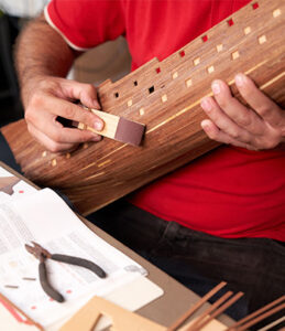 A man assembles a model of a ship.