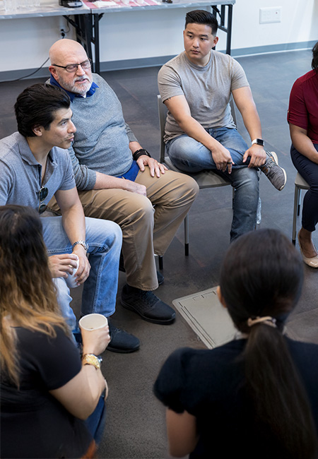 A mental health therapist responding to one of the veteran's questions during their group therapy session.