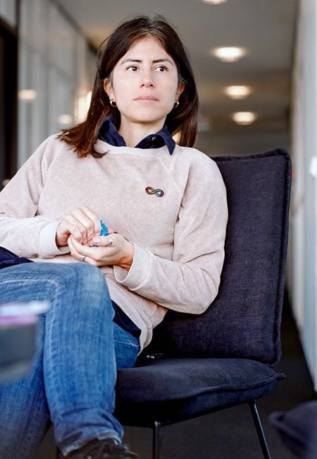 A professional with autism squeezes a stress ball in an office.