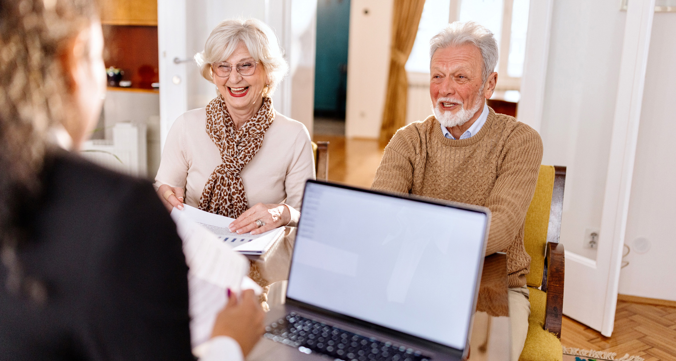An older couple collaborating with a financial advisor.