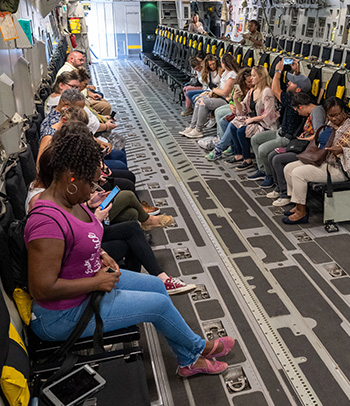 Military spouses board a C-17 Globemaster III for Pacific Air Forces’ Military Spouse Appreciation Day flight.