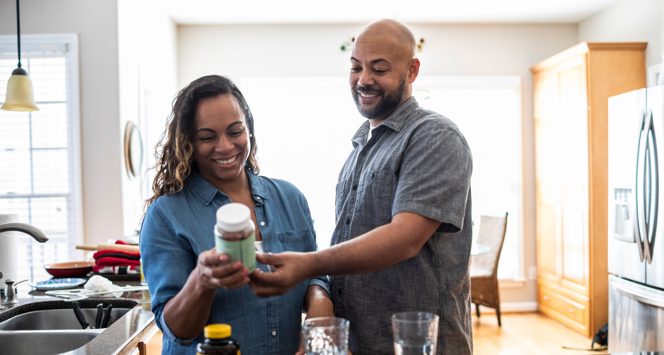 A husband and wife looking over supplement labels.