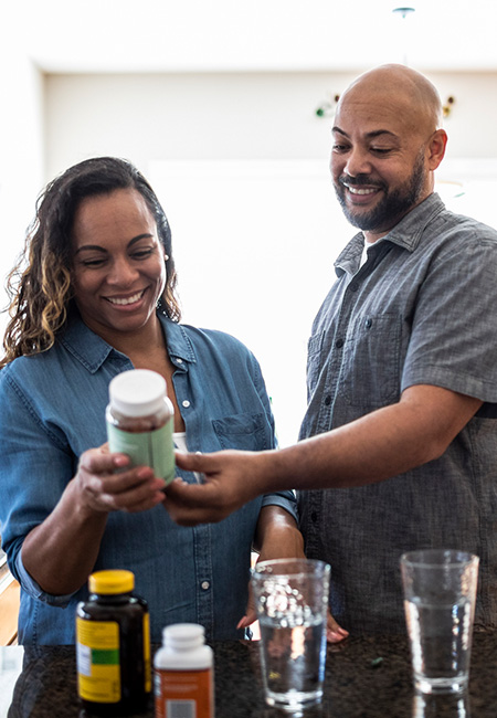 A husband and wife looking over supplement labels.