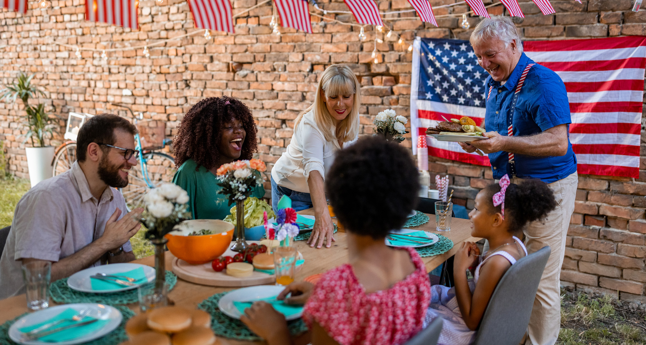 A multigeneration family has dinner outdoors on Labor Day.