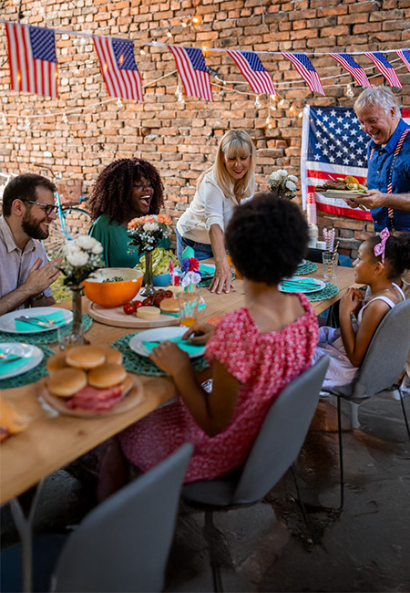 A multigeneration family has dinner outdoors on Labor Day.