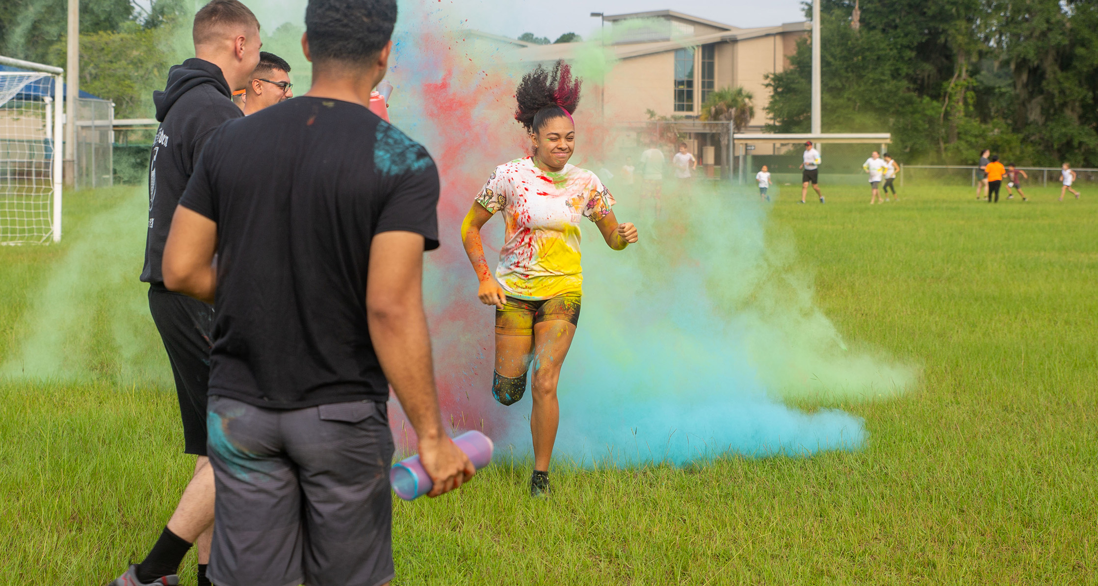 Families run through colored powder during the back-to-school Splash of Color event.