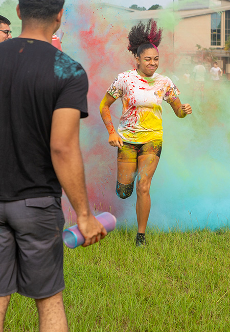 Families run through colored powder during the back-to-school Splash of Color event.