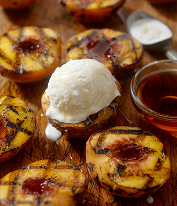 Grilled peaches with vanilla ice cream and maple syrup.