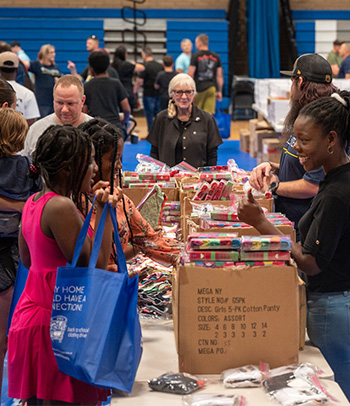 Volunteers distribute school supplies during the Back-to-School Bash.