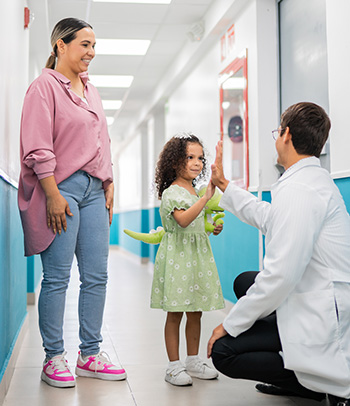 A mother and daughter leaving their appointment with her pediatrician.