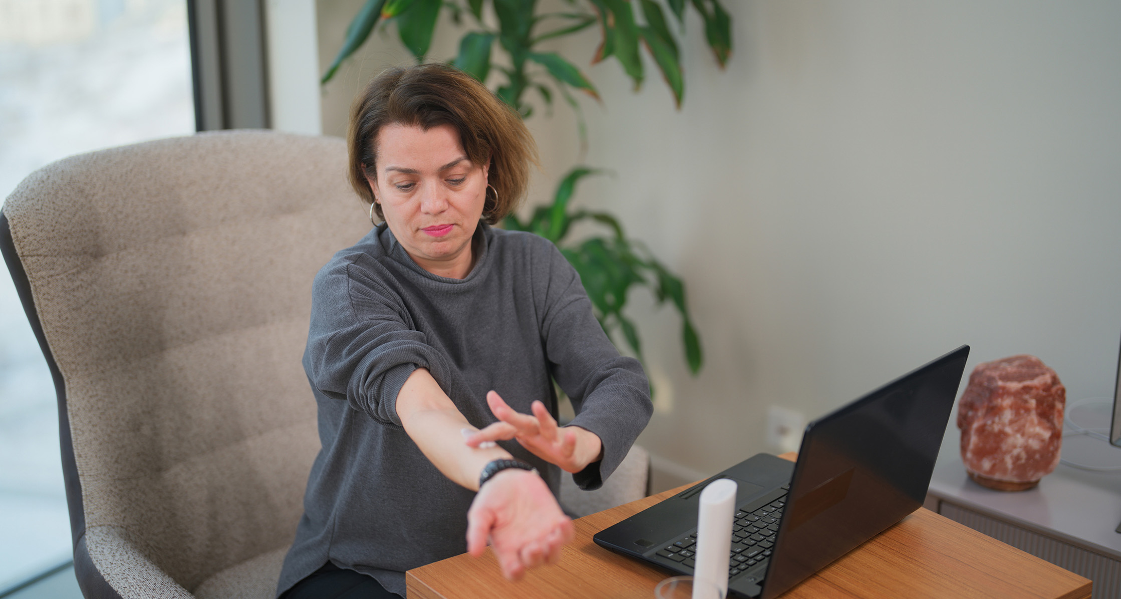 Woman applying hormone replacement therapy cream to her arm.