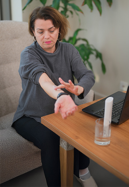 Woman applying hormone replacement therapy cream to her arm.