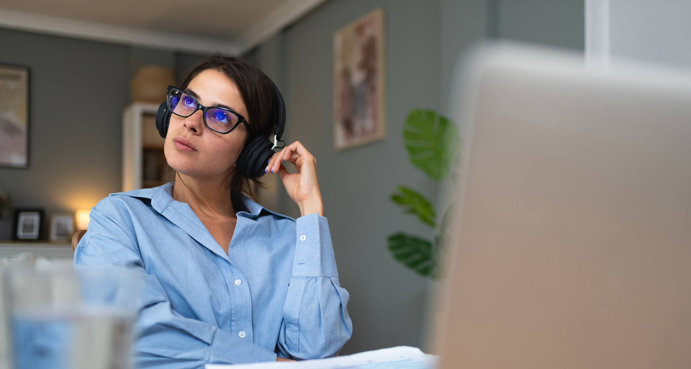 Woman looks distracted while working at her desk.