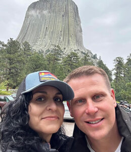 Cynthia Barris-Slovensky with husband visiting Devil's Tower in Wyoming.