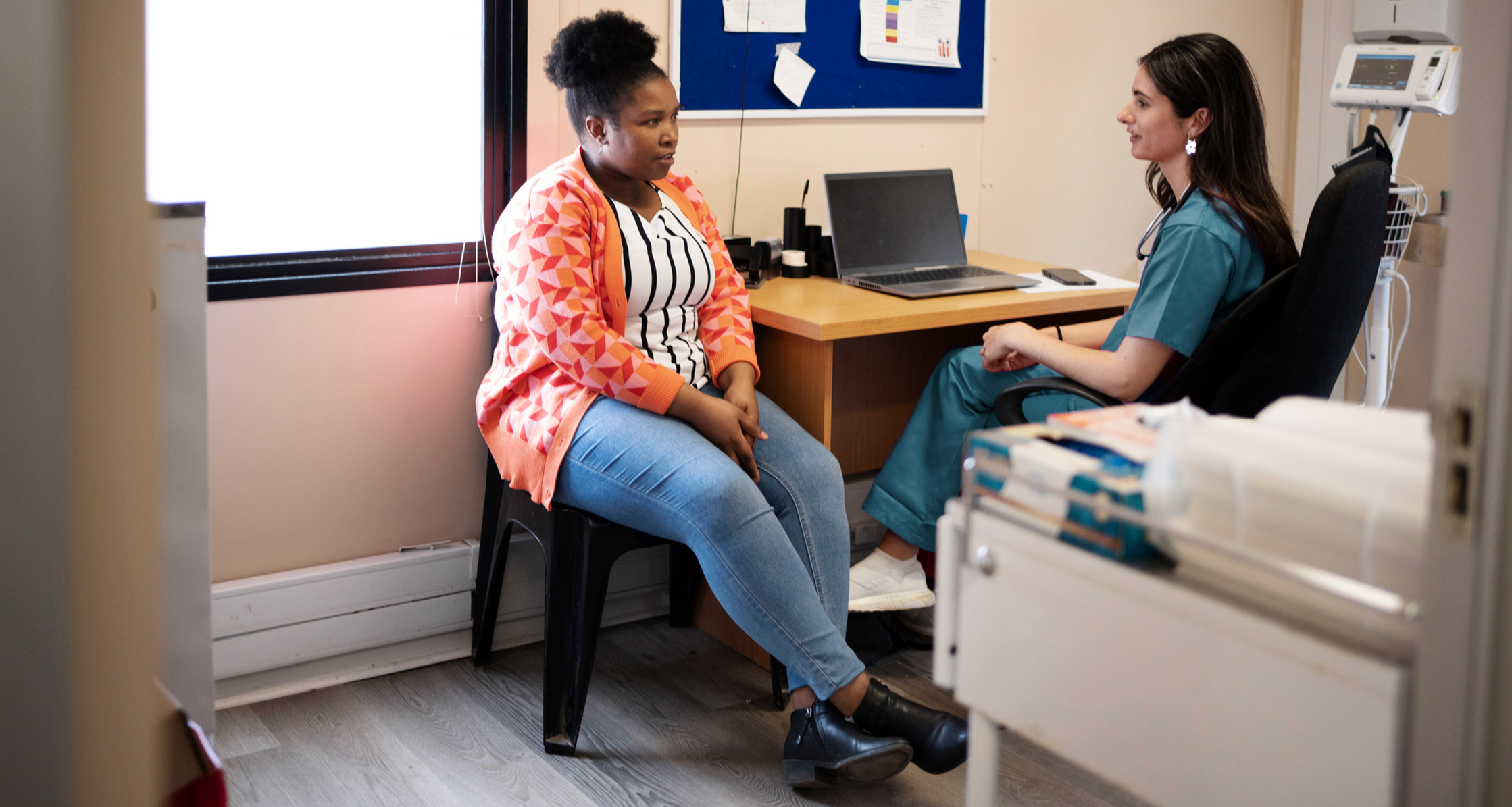 Patient speaks with a health care provider during a clinic visit.