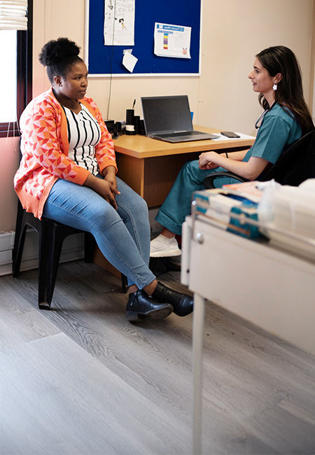 Patient speaks with a health care provider during a clinic visit.