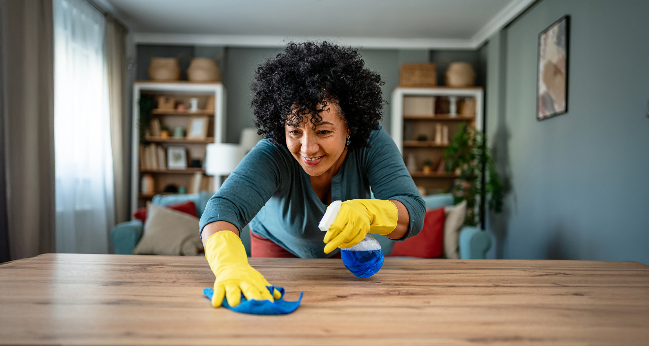 Person cleaning kitchen island.