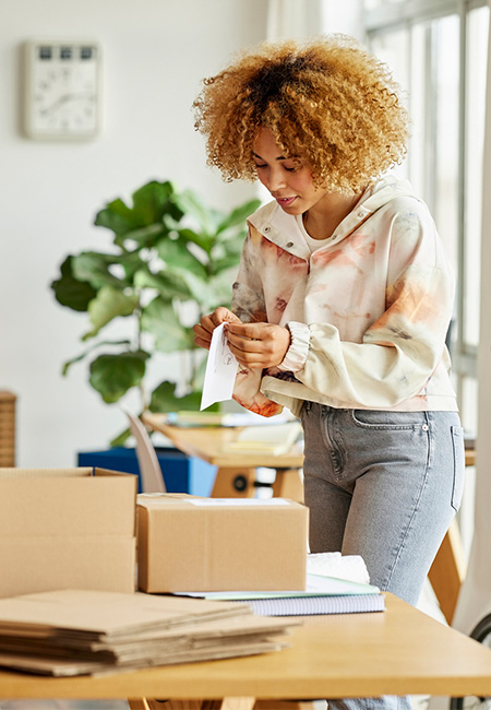 Entrepreneurs at home pack items to send by mail.