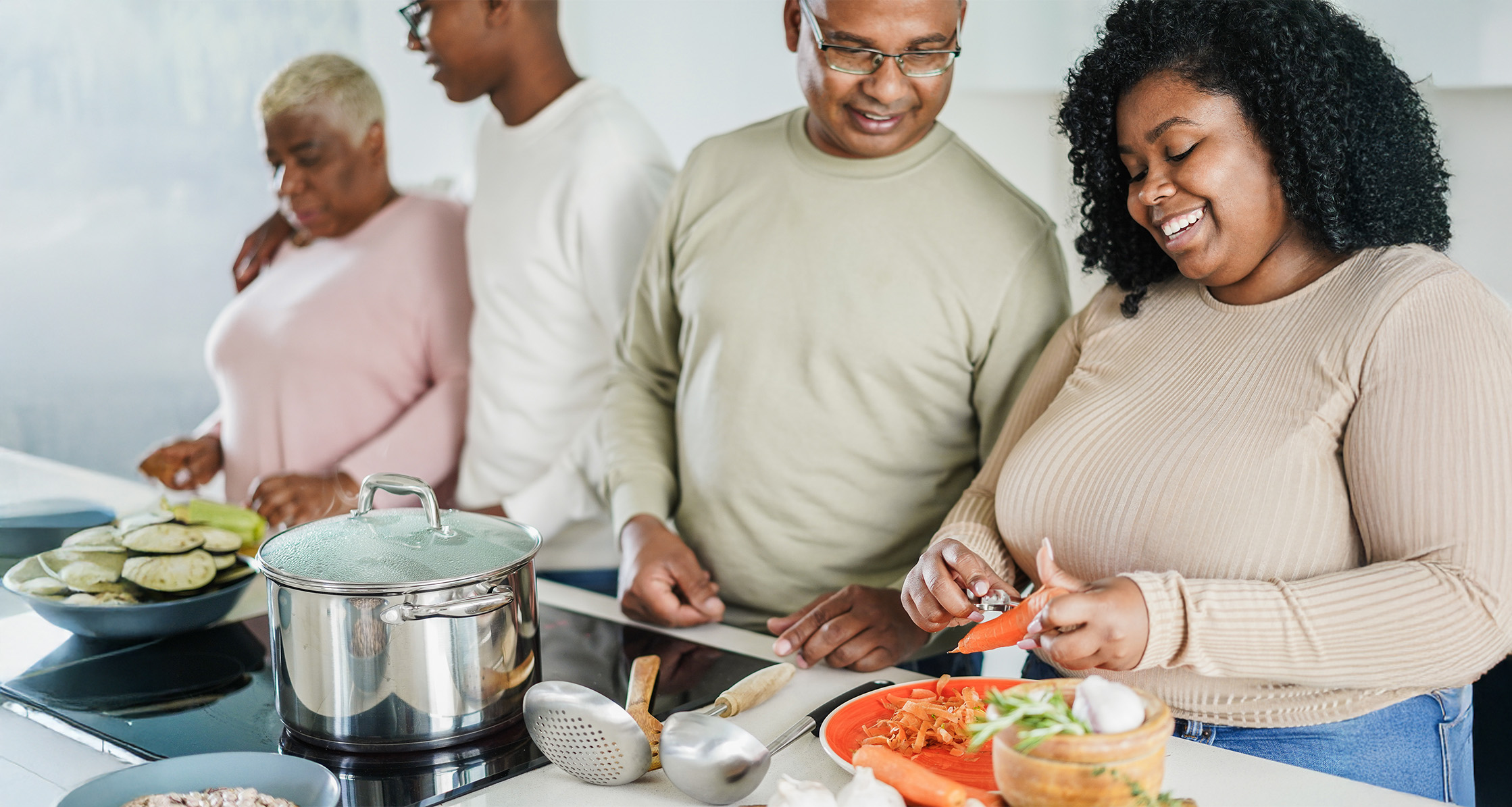 Family members cook and share a healthy meal together.