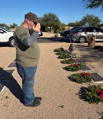 Man saluting grave