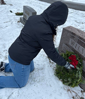 Woman placing wreath