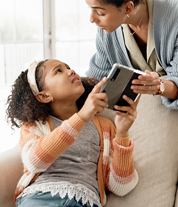 A mother takes phone away from daughter to limit screen time.