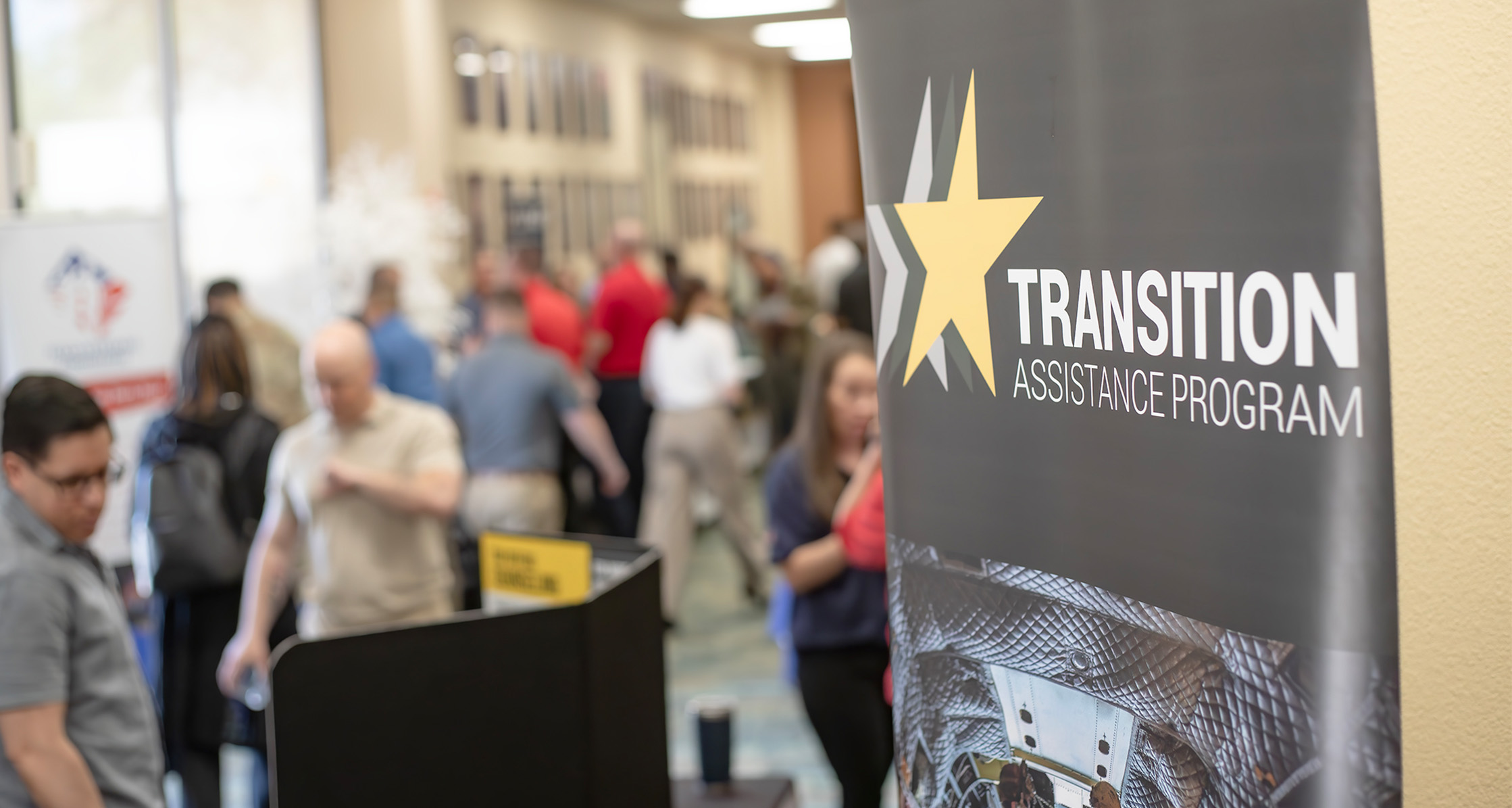 Guests fill the hall outside the main area of the annual Transition Assistance Program Workshop.