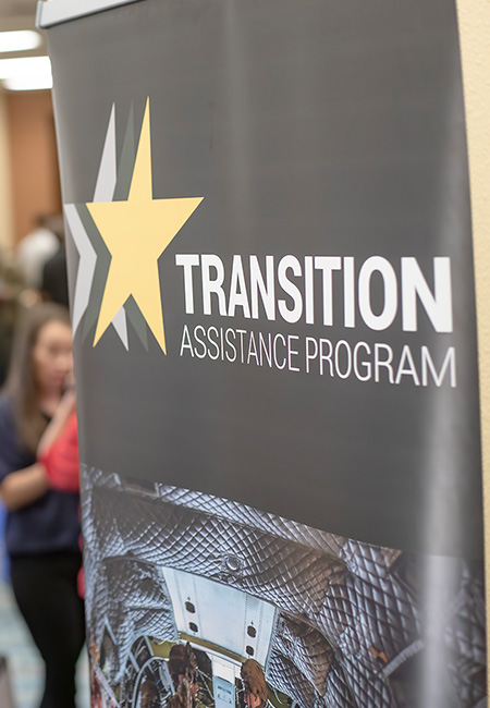 Guests fill the hall outside the main area of the annual Transition Assistance Program Workshop.