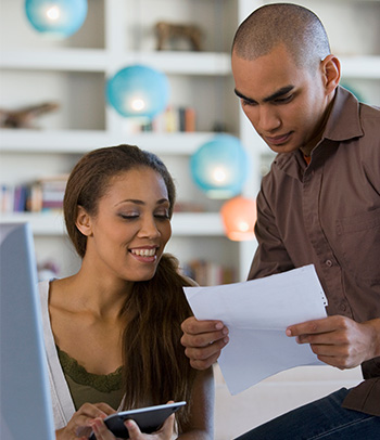 A couple works together to balance their monthly budget.
