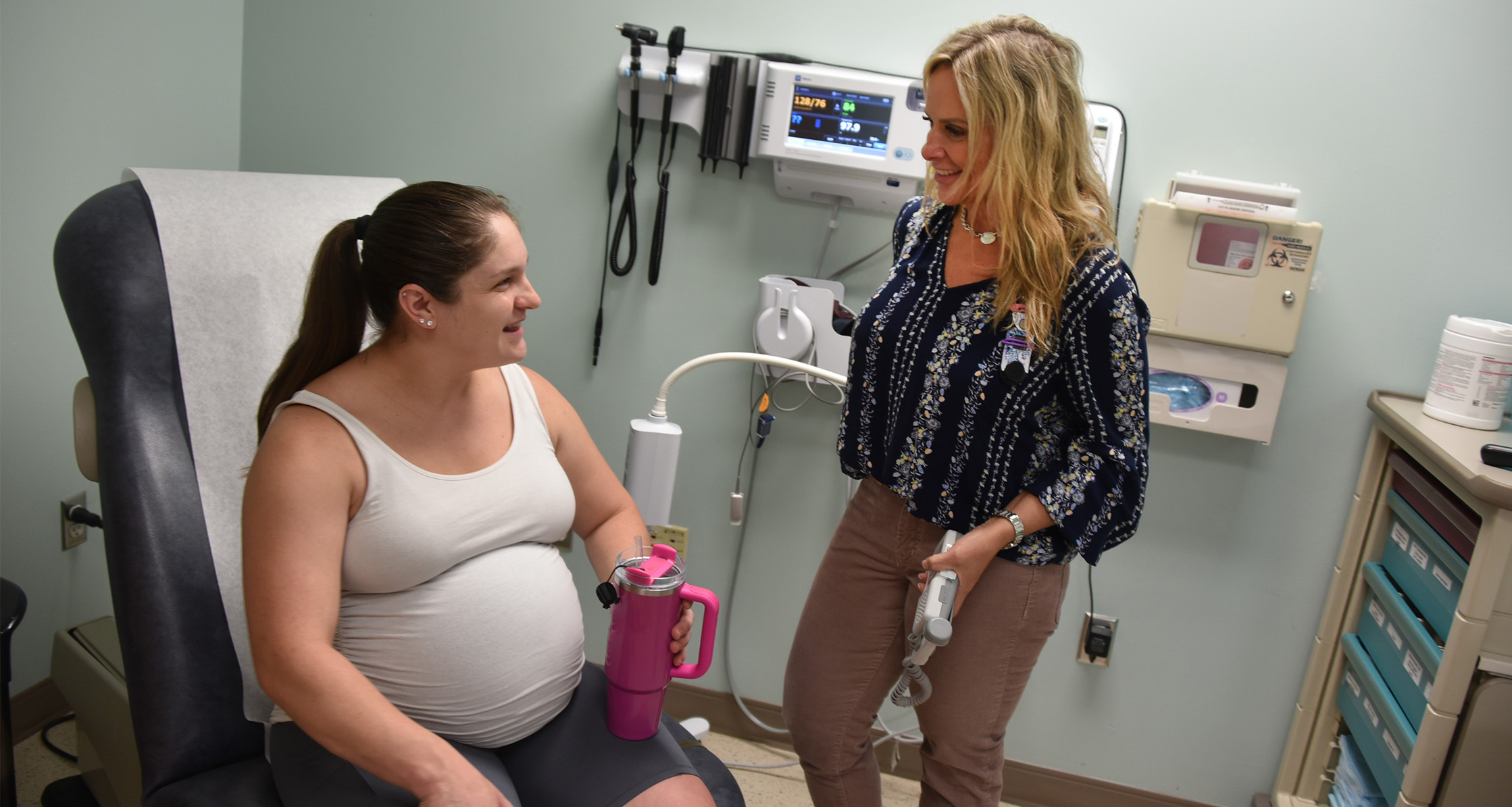 A patient talks to a doctor during a routine prenatal care appointment.