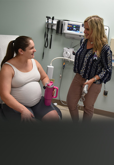 A patient talks to a doctor during a routine prenatal care appointment.