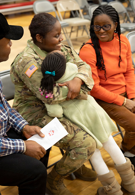 Families gather to say goodbye during a deployment ceremony.