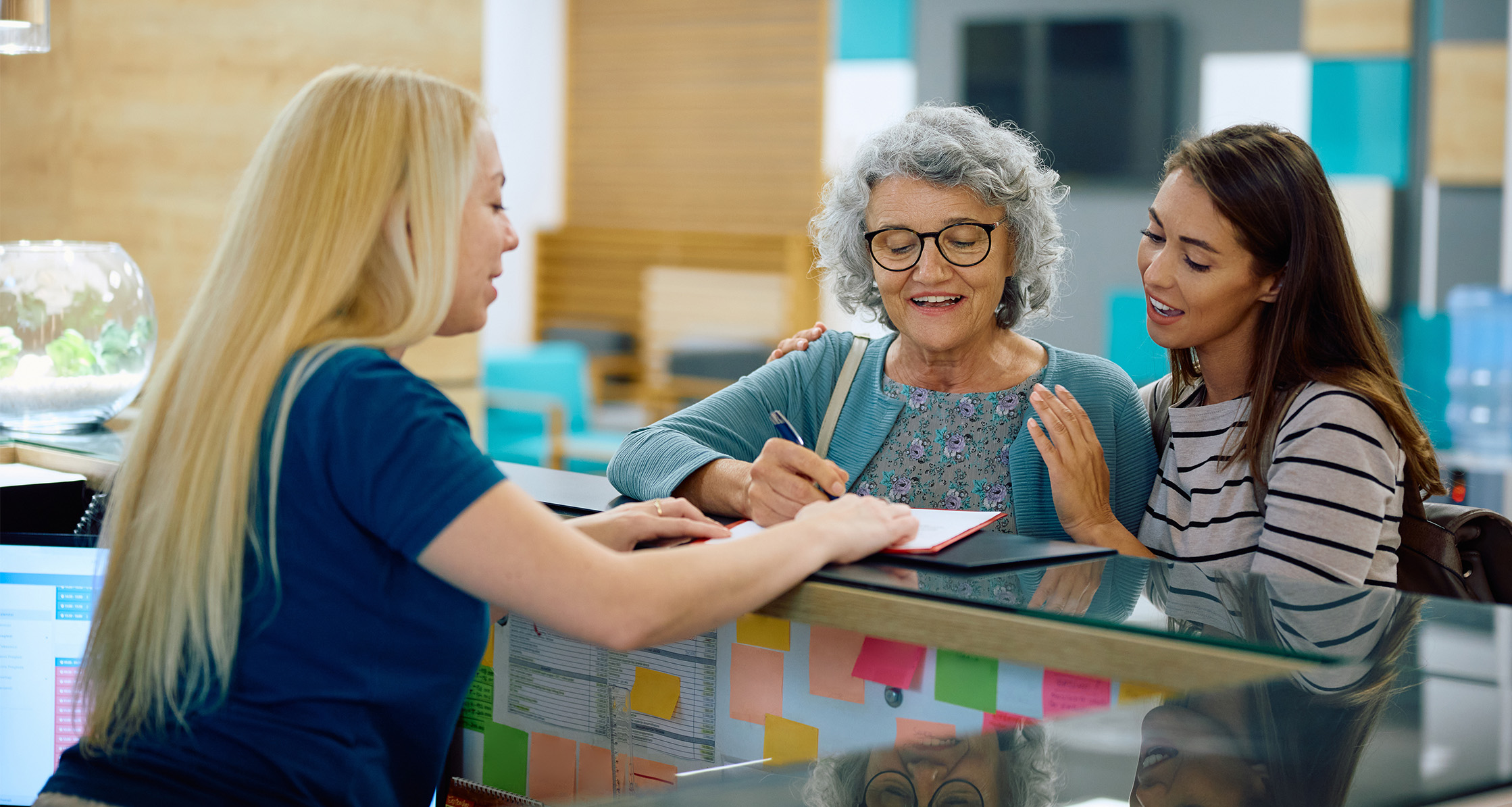 A Veteran with her caregiver checks in for medical appointment.