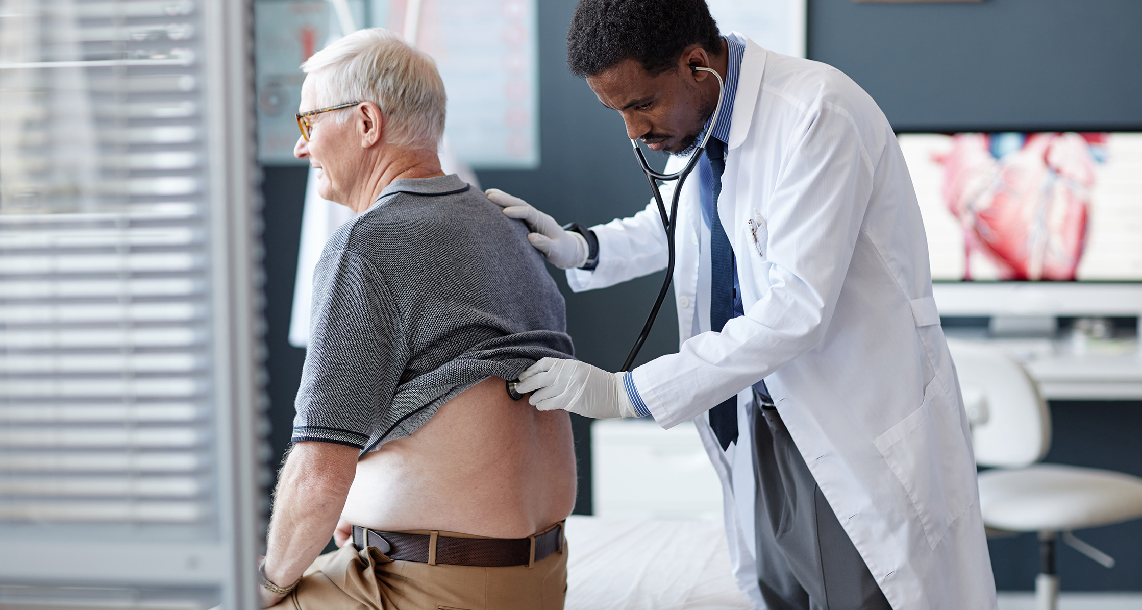 Doctor checks lung health in older patient.