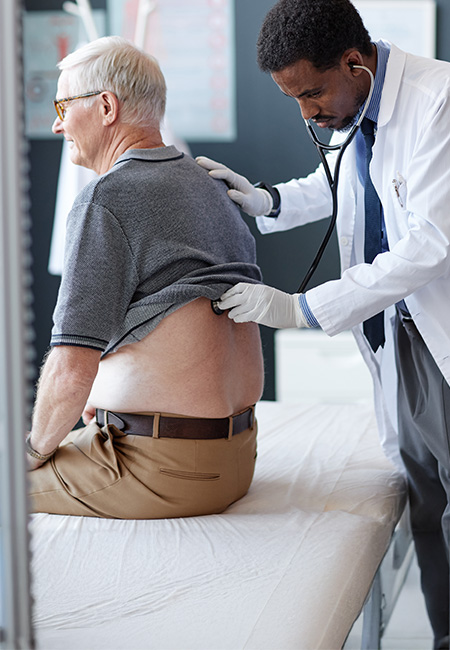 Doctor checks lung health in older patient.