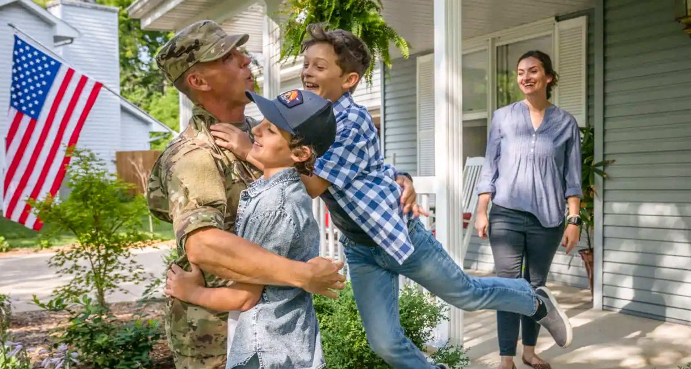 Military family outside their new home.