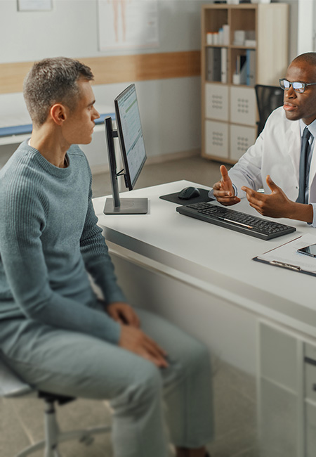 Veteran discussing health concerns with a medical provider during an office visit.
