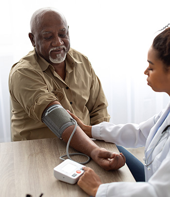 Veteran has blood pressure checked.