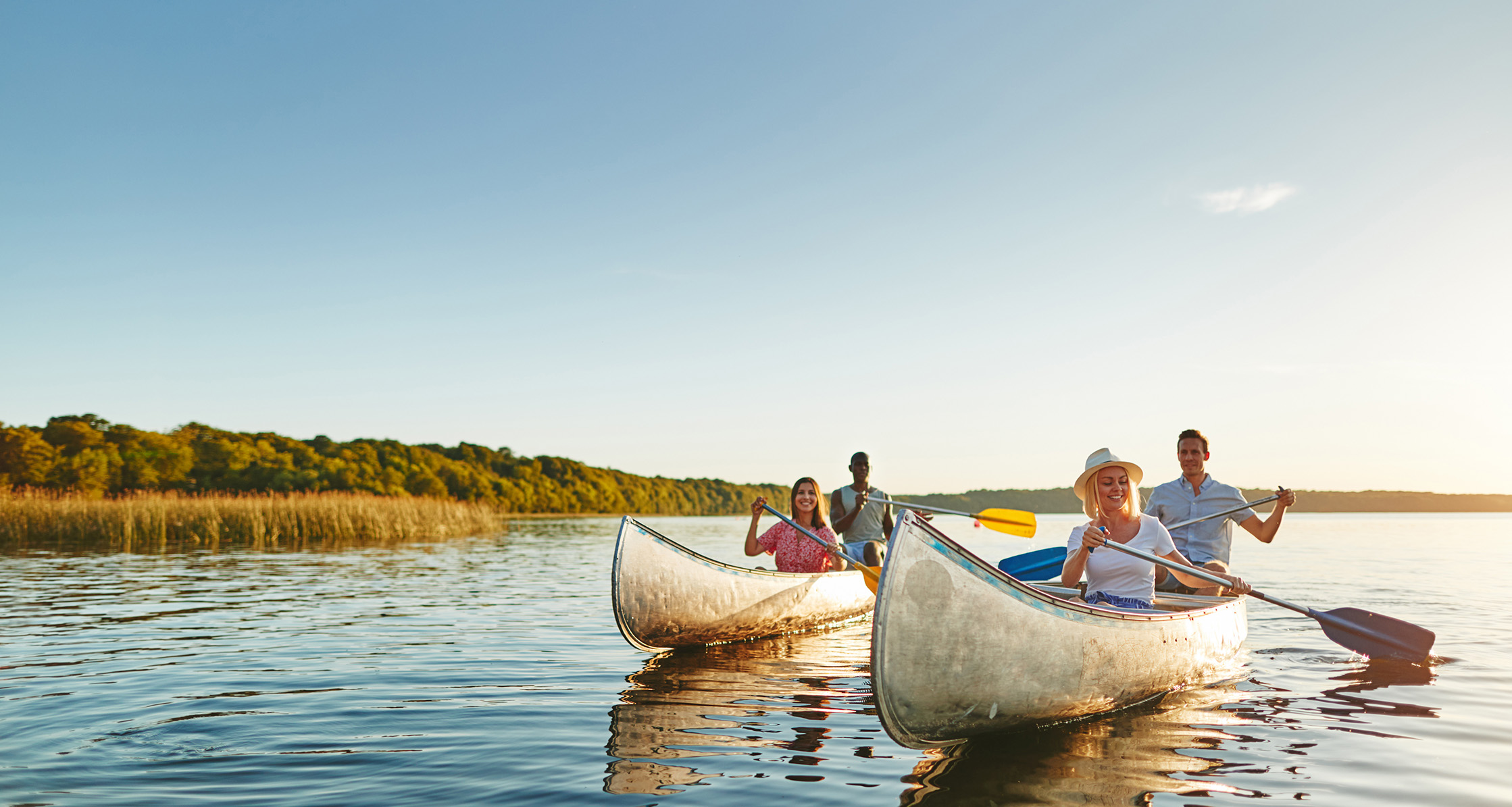 Group of adults canoeing, enjoying outdoor activity and fresh air.