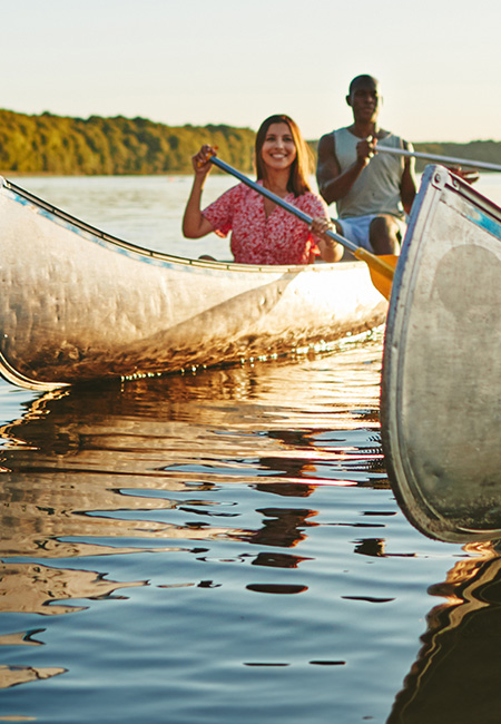 Group of adults canoeing, enjoying outdoor activity and fresh air.